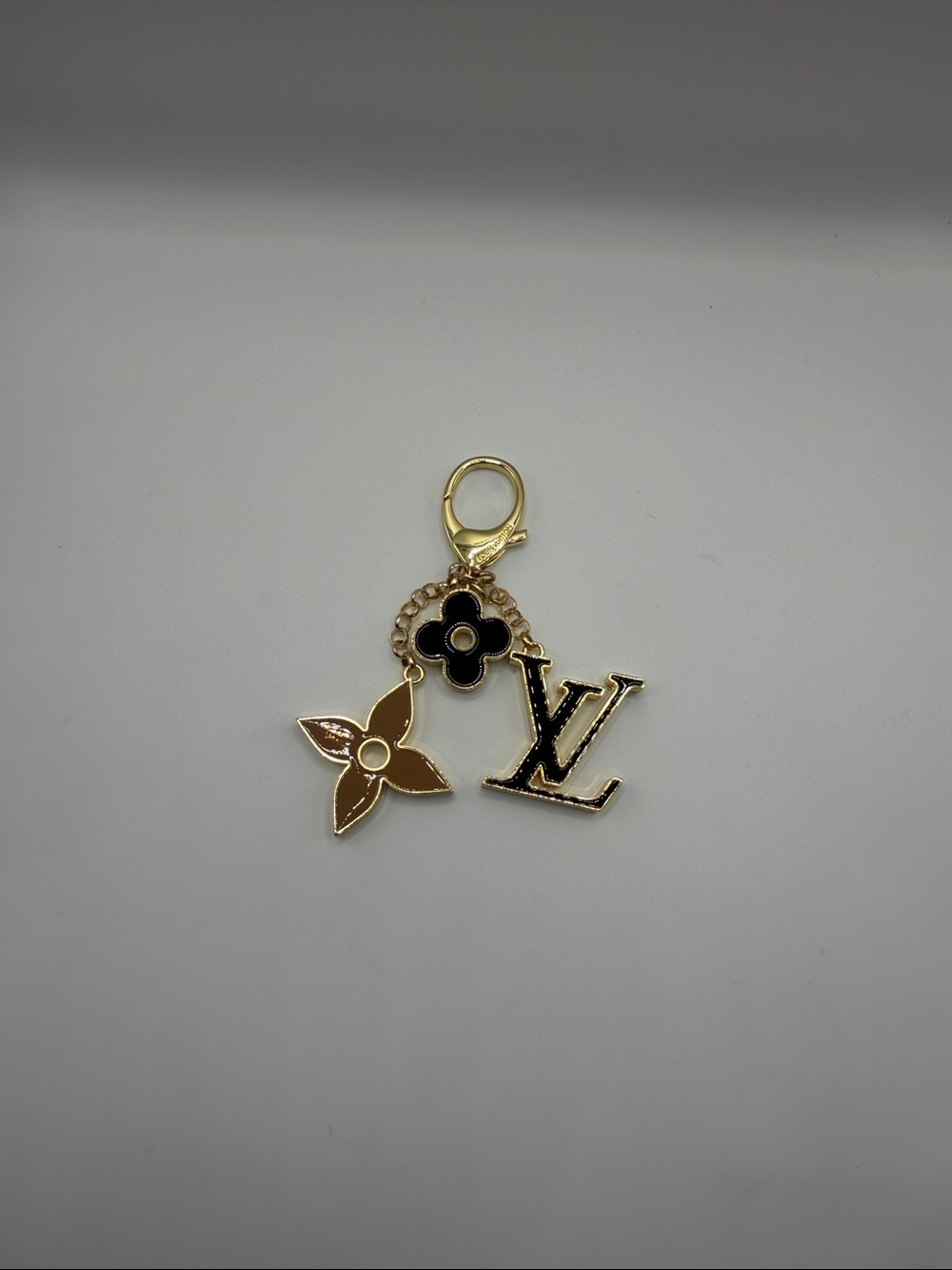 1445. Gold-Tone Logo Black-Tan Flower Charm Key Holder or Bag Charm.